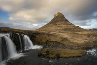 The Kirkjufell mountain and the kirkjufellfoss waterfall at grundarfjordur at Snaefellsnes