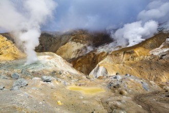 Beautiful volcanic landscape, crater of active volcano: hot spring, fumarole, lava field, gas-steam