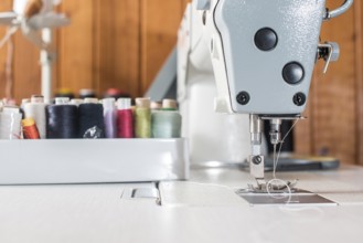 Woman sewing on a sewing machine. Close up