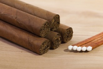 Different cigars on wooden table