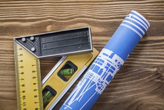 Blue construction drawing level square ruler on wooden board