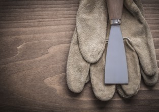 Paint scraper on safety glove
