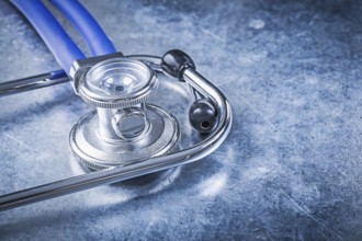 Stethoscope on scratched metallic background top view medicine concept