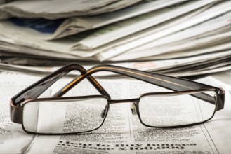 Glasses on newspaper. Natural lightings