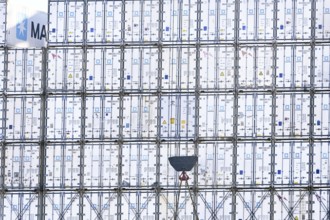 Stacked containers of the Danish logistics company Maersk on a container ship in the port of