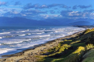 Powerful ocean surf on South island. Sunset. Rocky and stone shores of the ocean. The southernmost