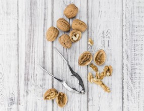 Walnuts on an old wooden table as detailed close-up shot (selective focus)