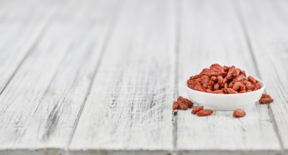 Fresh made Dried Goji Berries on a vintage background (close-up shot)