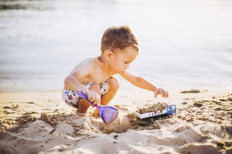 Kids Play On Beach. Sand And Water Toy. Truck toy car with sand and soil. green environment