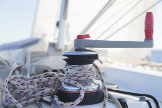 Winch with rope on sailing boat in the sea