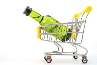 Selling alcohol in a store. Green bottle in a supermarket cart. Drink in a green bottle