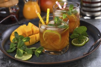 Mango iced tea with lime and mint. Refreshing organic soft drink