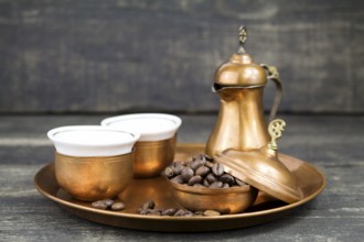 Turkish coffee with traditional copper serving set and coffee beans