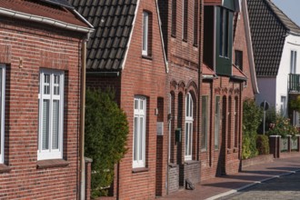 Row of historic brick houses with many windows, Ditzum, east frisia, germany