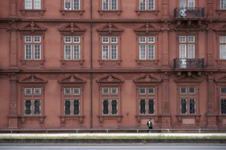 Mainz, Germany - June 24, 2015: A tourist wearing a green waistcoat and hiking clothes walks along