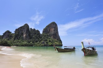Two richly decorated antique boat Longtail on a beach in Thailand