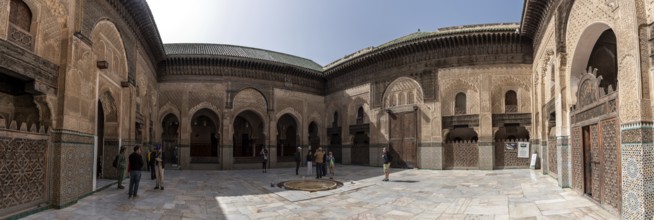 Fes, Morocco, April 05, 2023, Traditional oriental facade at the courtyard of madrasa Bou Inaniya