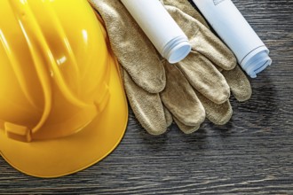 Leather protective gloves construction plans hard hat on wooden board