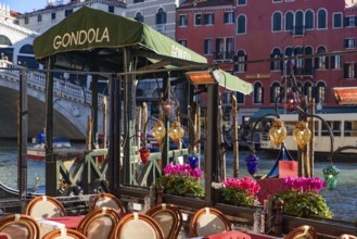 View of the Grand Canal, Rialto Bridge, and gondolas from outdoor restaurant seats, Venice, Italy