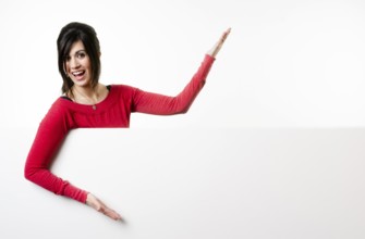 Woman smiles at she stands in between white spaces