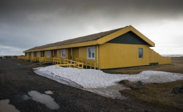 Yellow metallic cottage houses during wintertime in Iceland