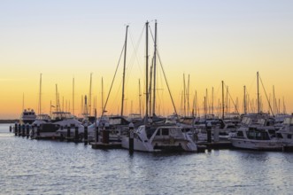 Sunset over the Hillarys marina full of mooring boats, Perth, WA, Australia