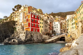 View of the historic center seen from the sea on a sunny day. Riomaggiore, Liguria. Italy