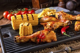 Rustic Grilled chicken wings, legs, and spicy corn