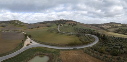 A long winding road leading to the Tuscan hilltop village of Pienza