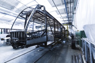 One working day of modern automatic bus trolleybus car production with unfinished cars workers in