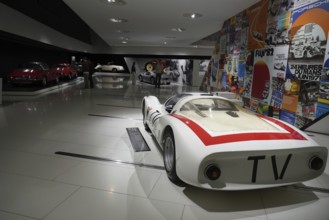 Porsche 906 Carerra 6, white racing car with red stripes, embedded in a colourful historical