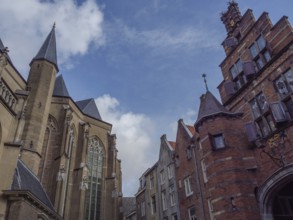 Gothic church and historic buildings under a blue sky, nijmegen, gelderland, the netherlands