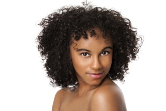 Beautiful happy female face with smooth skin and dark curly hair, isolated, New York, USA