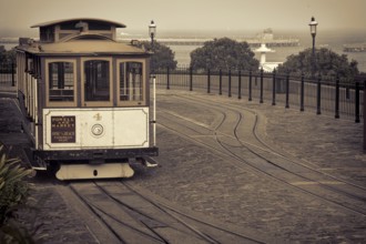 San Francisco cable car at Hyde Street turntable (Fisherman's Wharf) with foggy Aquatic Park in