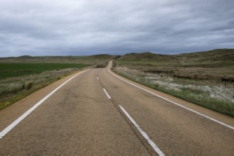 Country road under a cloudy sky in Extremadura, Spain