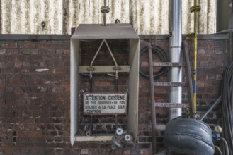 Industrial wall with signs and old metallic structures, clearly visible decay, steelworks HF4, Lost