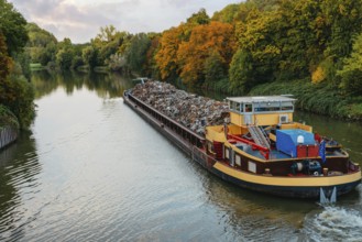 Transportation industry. Ship barge transports scrap metal and sand with gravel. Barge loaded with