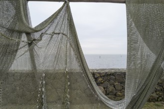 Fishing nets to dry on the road by the sea