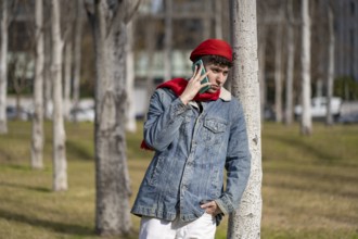 Young man talking on cell phone in a park