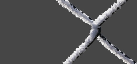 A chain-link fence with hoarfrost