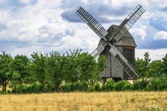 A view of a beautiful windmill in Thuringia Germany in a natural setting and an eye catcher for