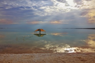 Winter in the Dead Sea. Excellent optical effects and reflections of clouds and sun in the water.