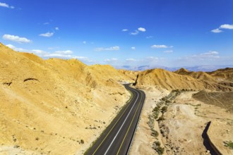 Israel. Desert on the shores of the Dead Sea. Asphalt highway meanders among the hills. Dead Sea