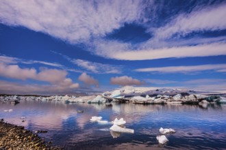 The concept of northern extreme tourism. The ice floes and cirrocumulus clouds of lagoon