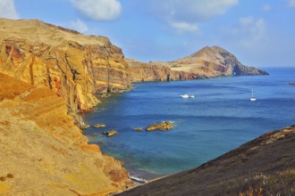 White yachts lit sunset. Quiet ocean cove on the island of Madeira. Calm on the Atlantic Ocean