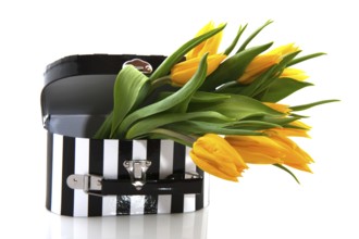 Black and white suitcase with yellow tulips