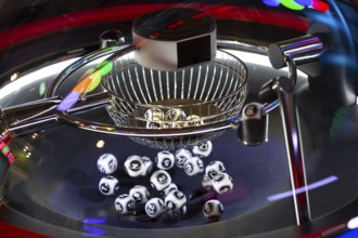 Black and white lottery balls in a rotating bingo machine. Lottery balls in a sphere in motion.