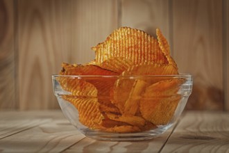 Transparent Glass Bowl Of Potato Chips With Paprika