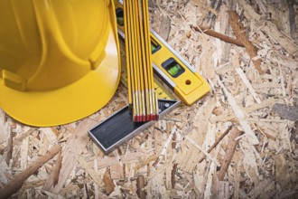 Square ruler construction level wooden meter hard hat on chipboard
