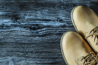 Pair of safety boots on vintage wooden board